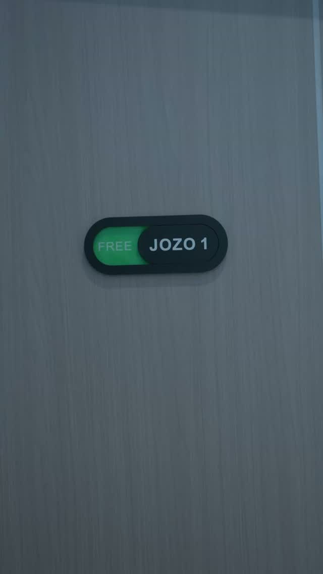 A dark door plaque reading “FREE JOZO 1.”