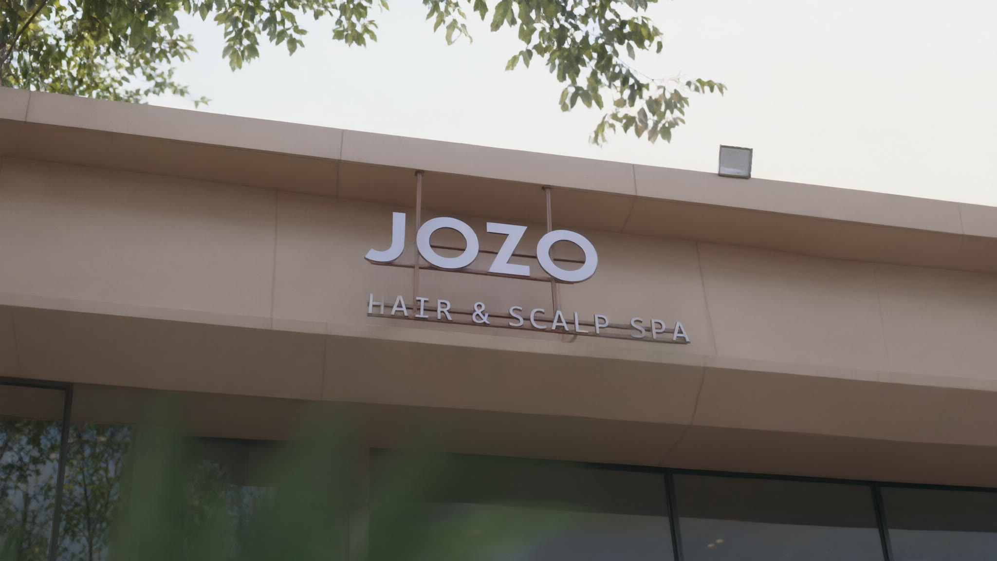 The JOZO Hair & Scalp Spa storefront sign on its facade.